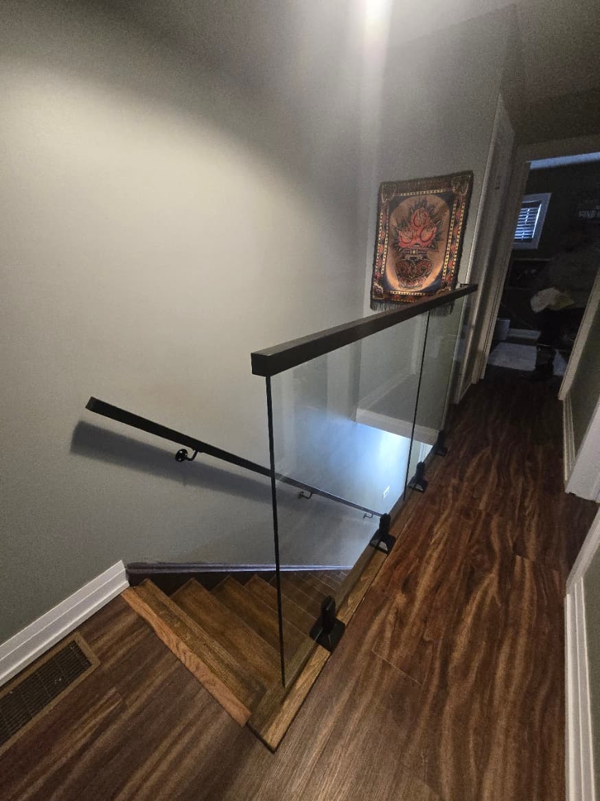 Frameless glass channel railing on interior stairs