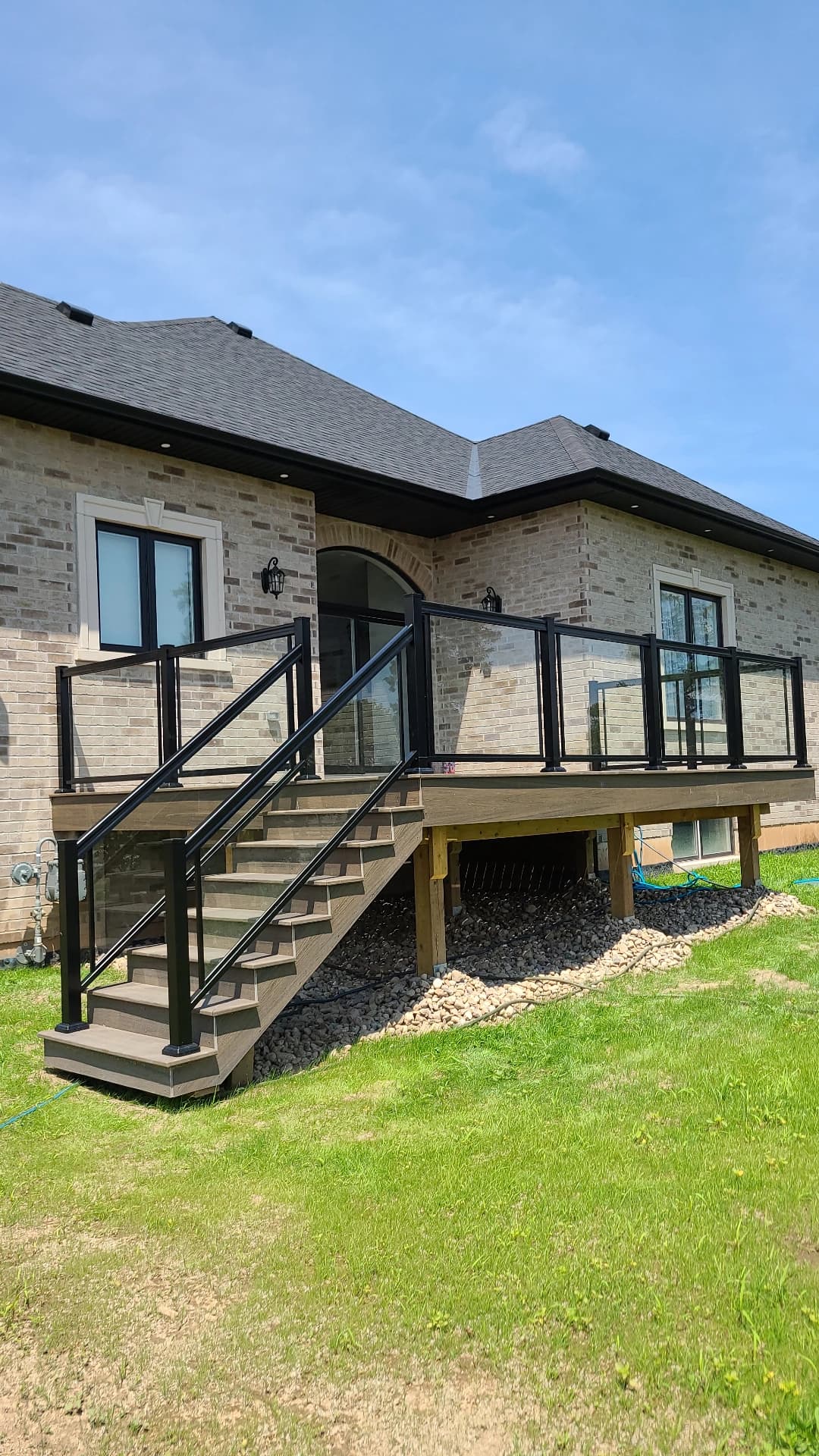 Framed glass railing with aluminum posts on a front porch