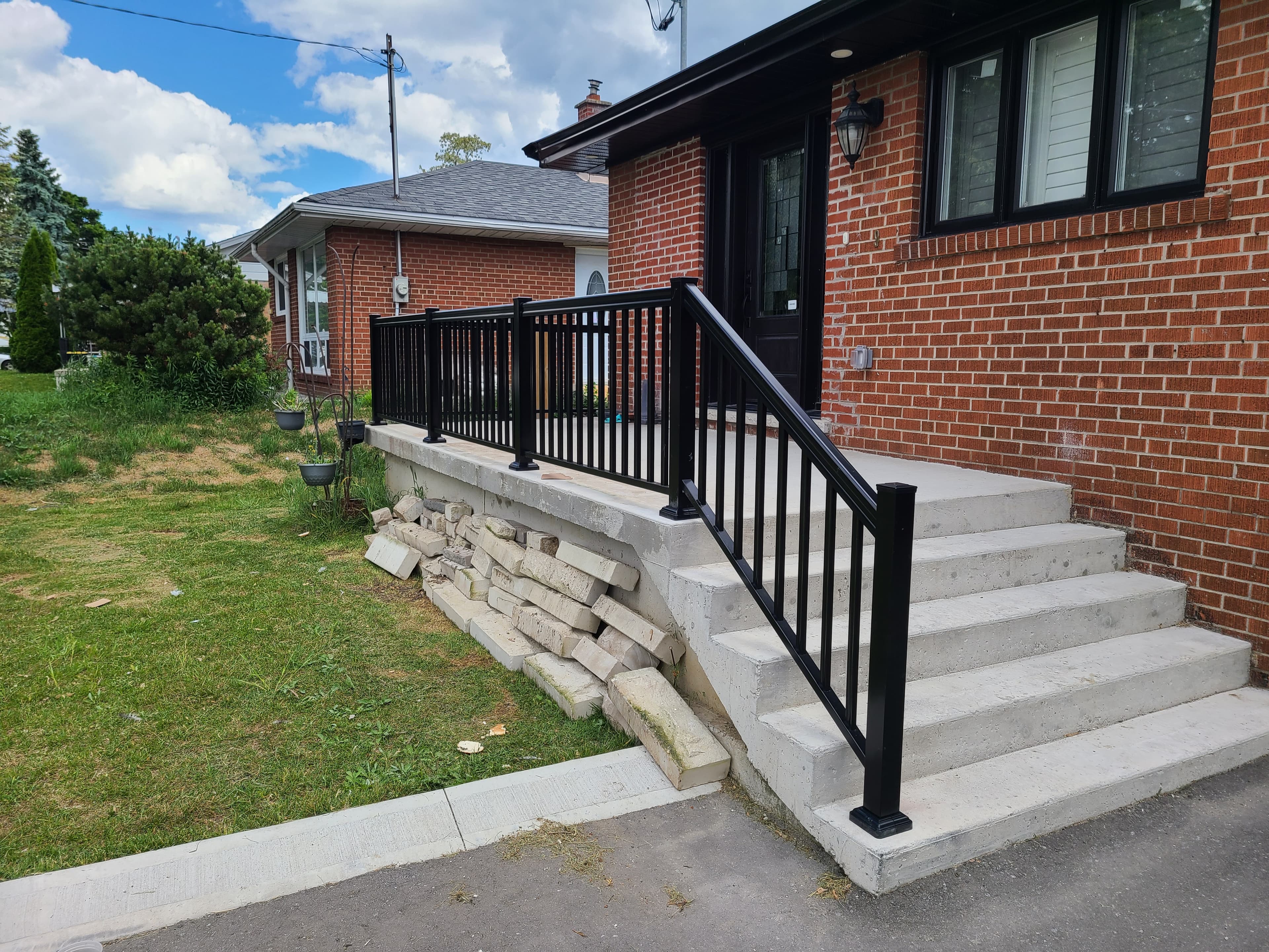 Straight aluminum picket railing on exterior stairs