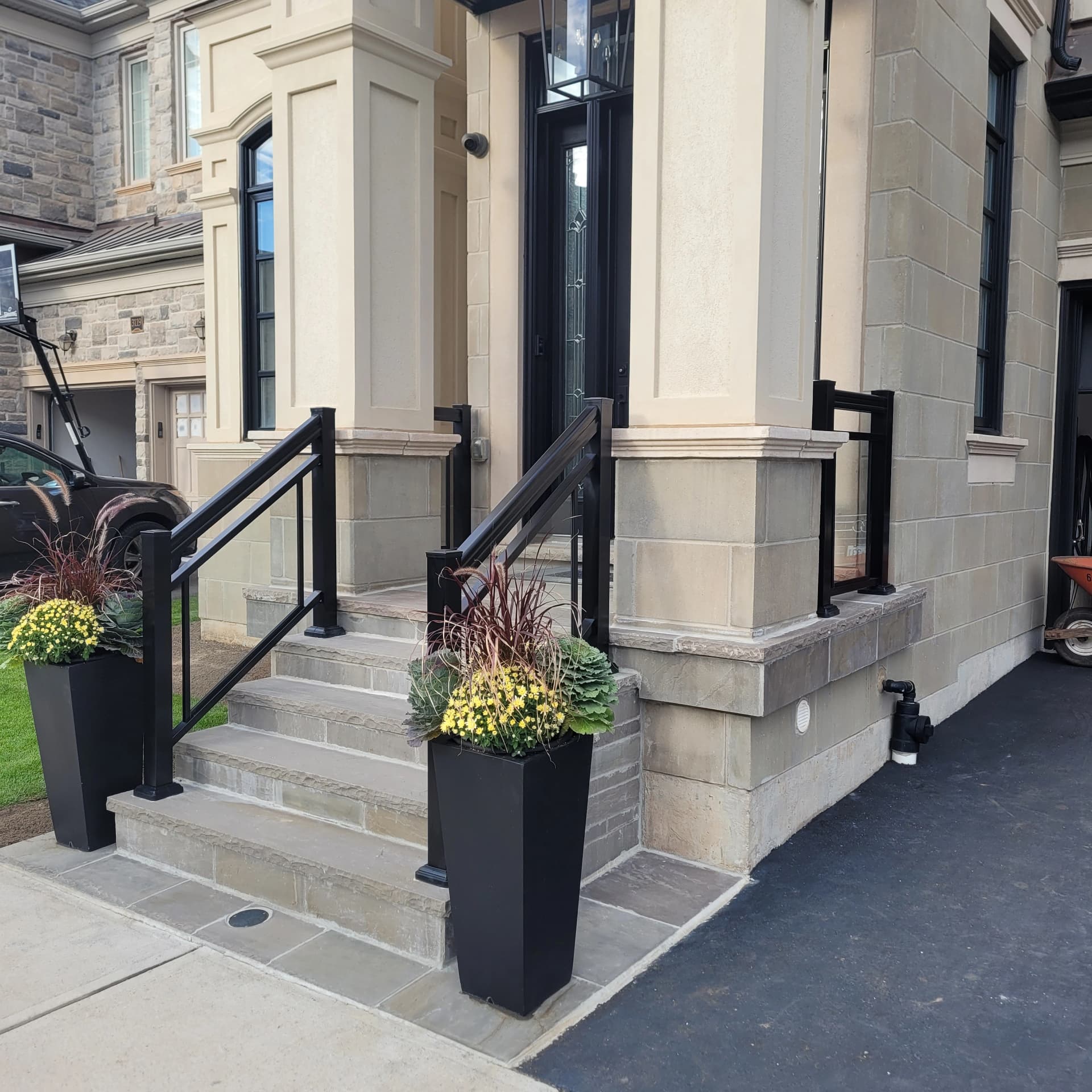 Framed glass railing with double bar on stone entry