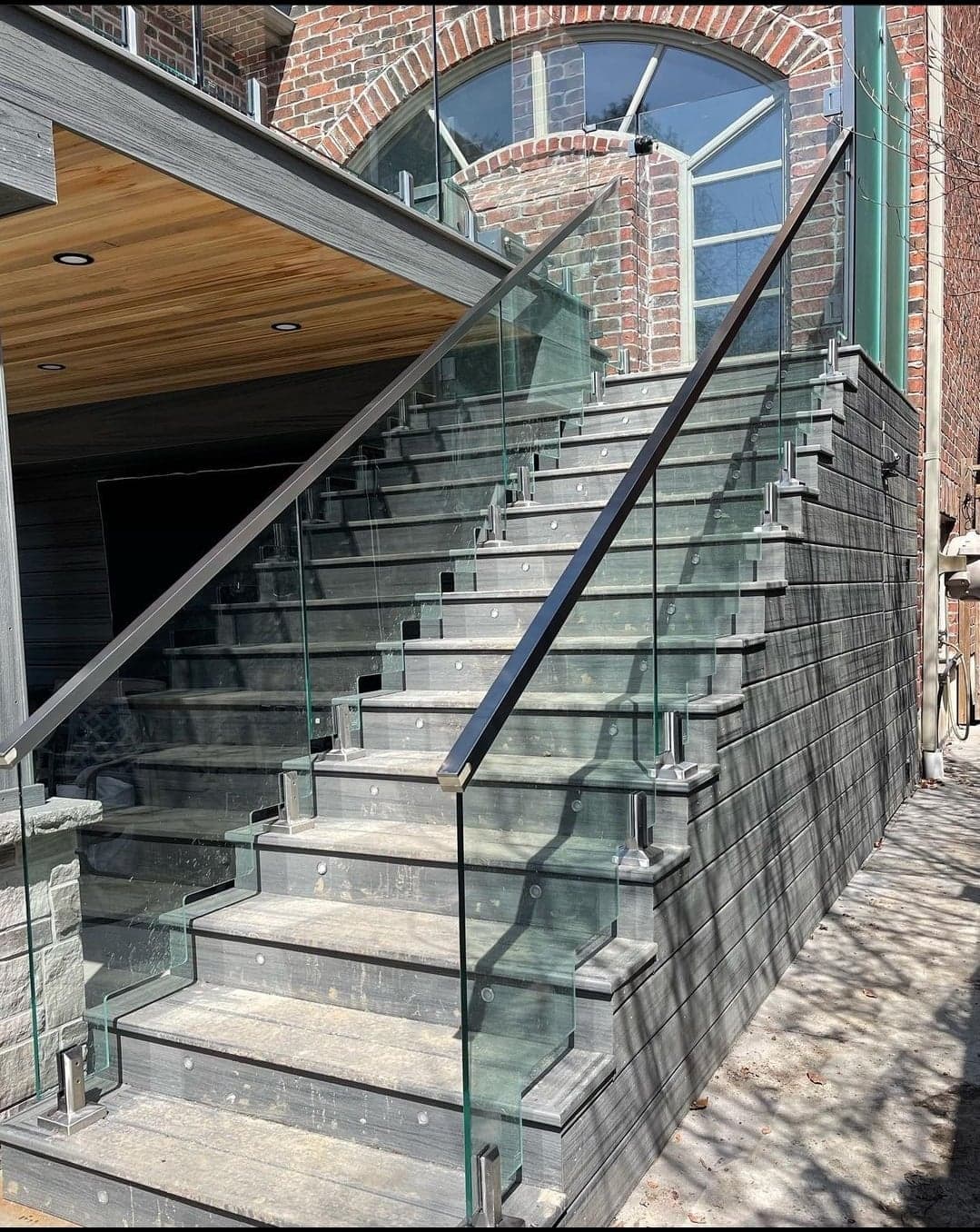 Glass railing on curved exterior stairs