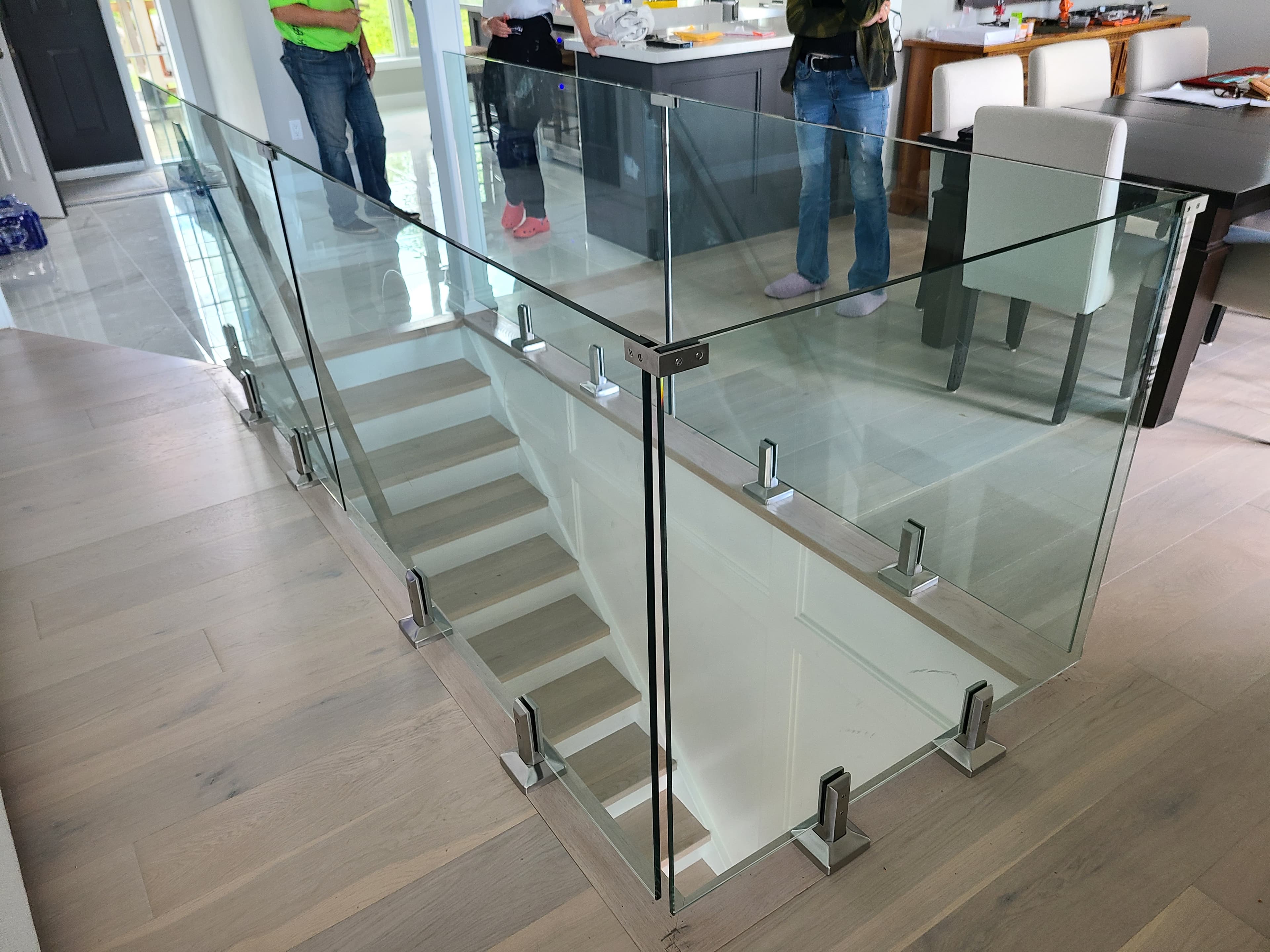 Spigot mounted frameless glass railing on interior staircase