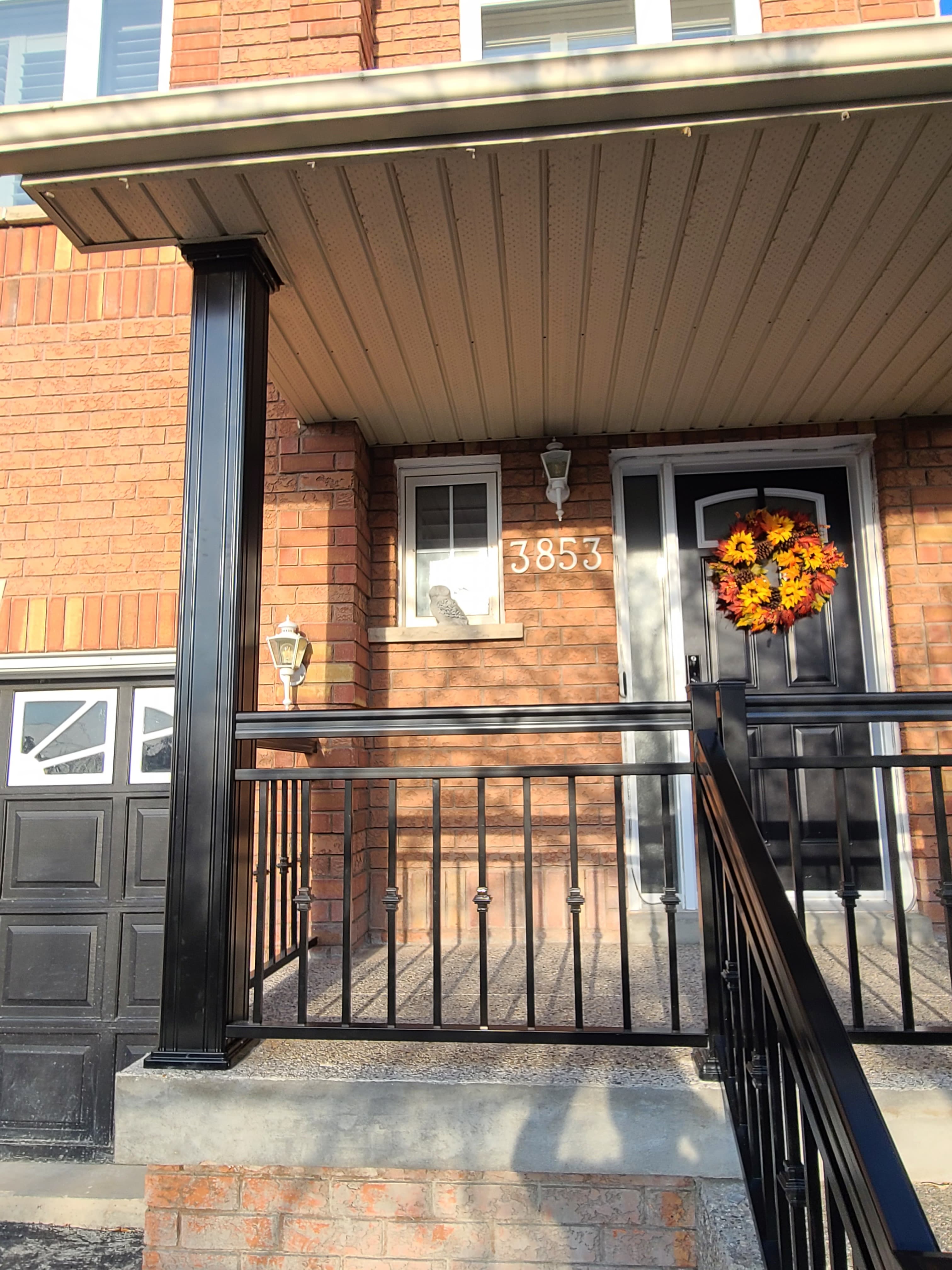 Decorative aluminum columns framing a front entry