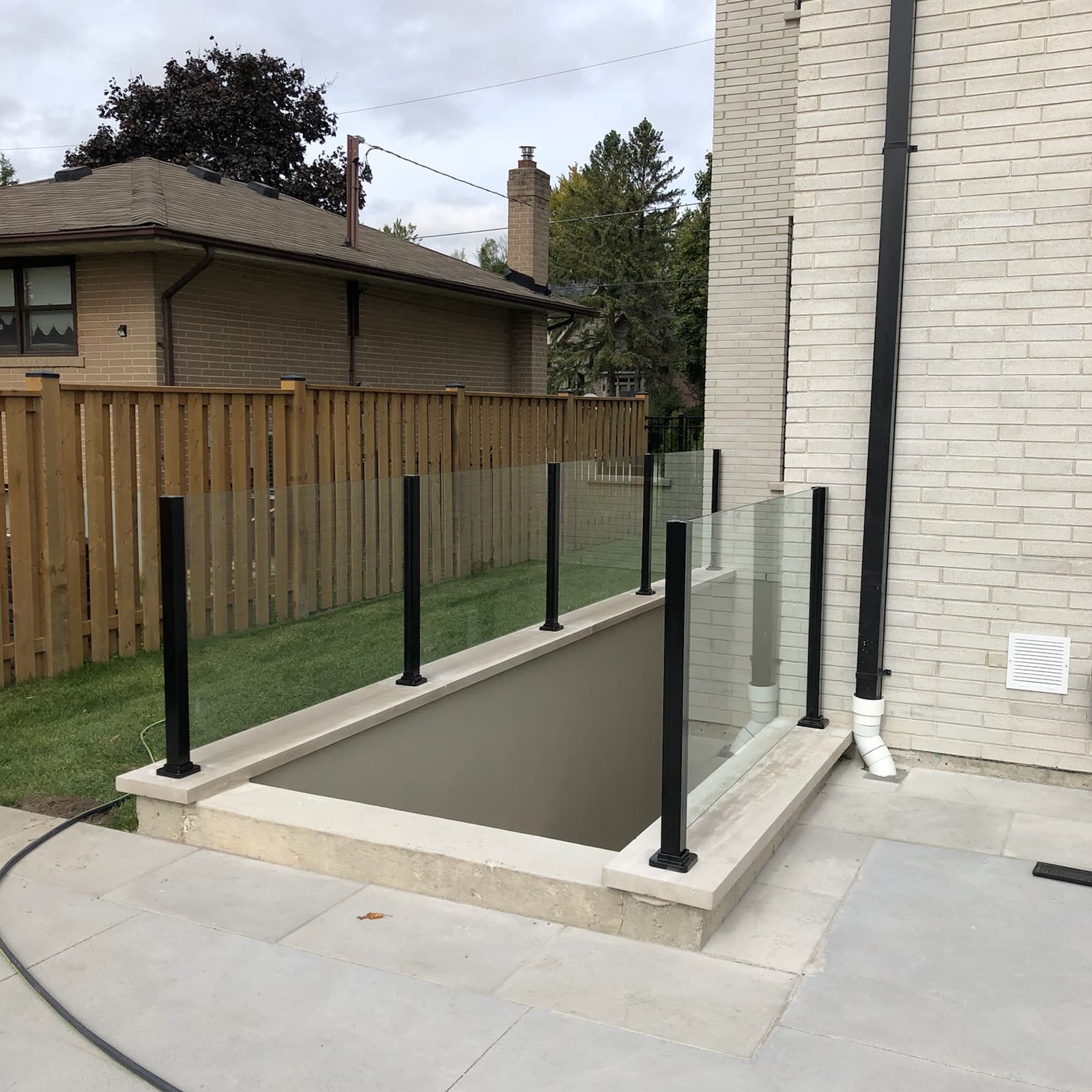 Frameless glass pool enclosure railing meeting Ontario safety requirements